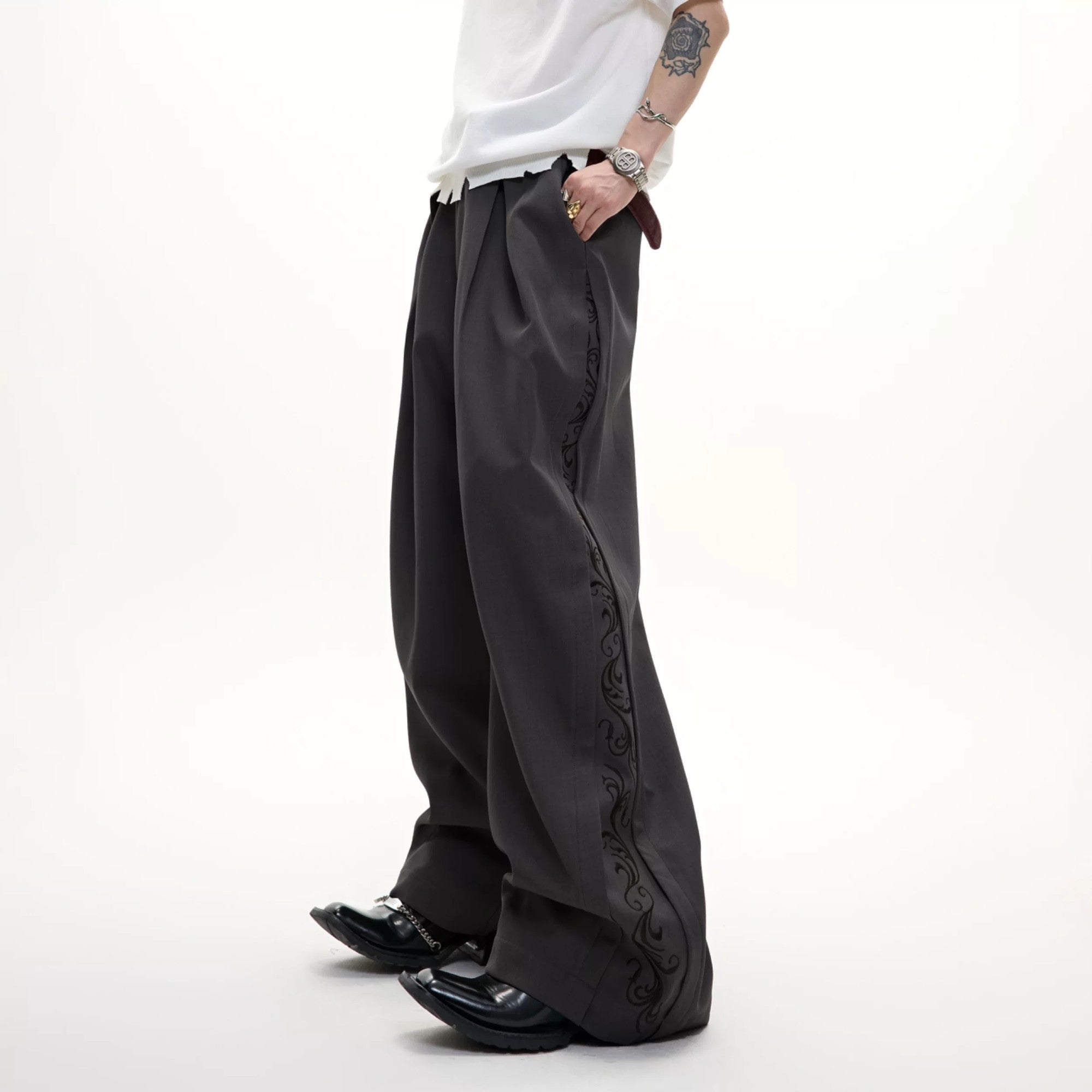 Front view of gray 3d cut pleated wide-leg trousers for men.