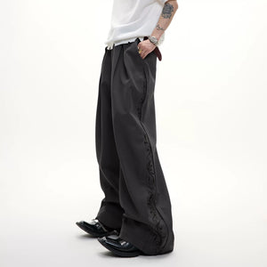 Front view of gray 3d cut pleated wide-leg trousers for men.