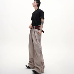 Back view of black vintage pleated wide-leg trousers.