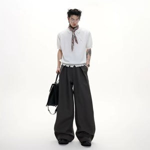 White wide-leg tailored trousers styled in an urban setting.