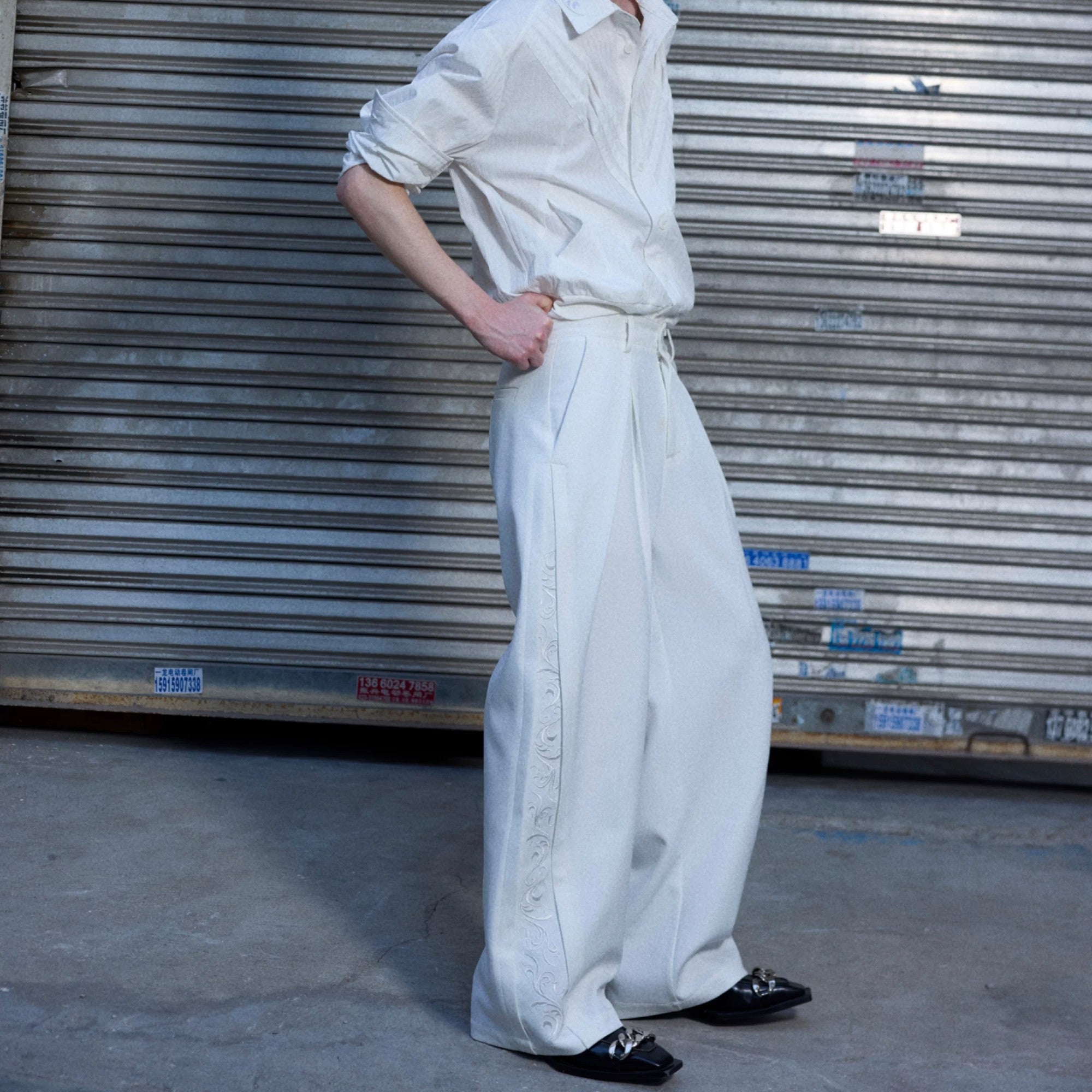 Black baggy streetwear trousers showing side quilted stitching and fit.