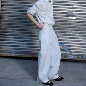 Black baggy streetwear trousers showing side quilted stitching and fit.