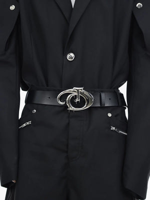 Close up of the irregular metal logo on a black streetwear belt