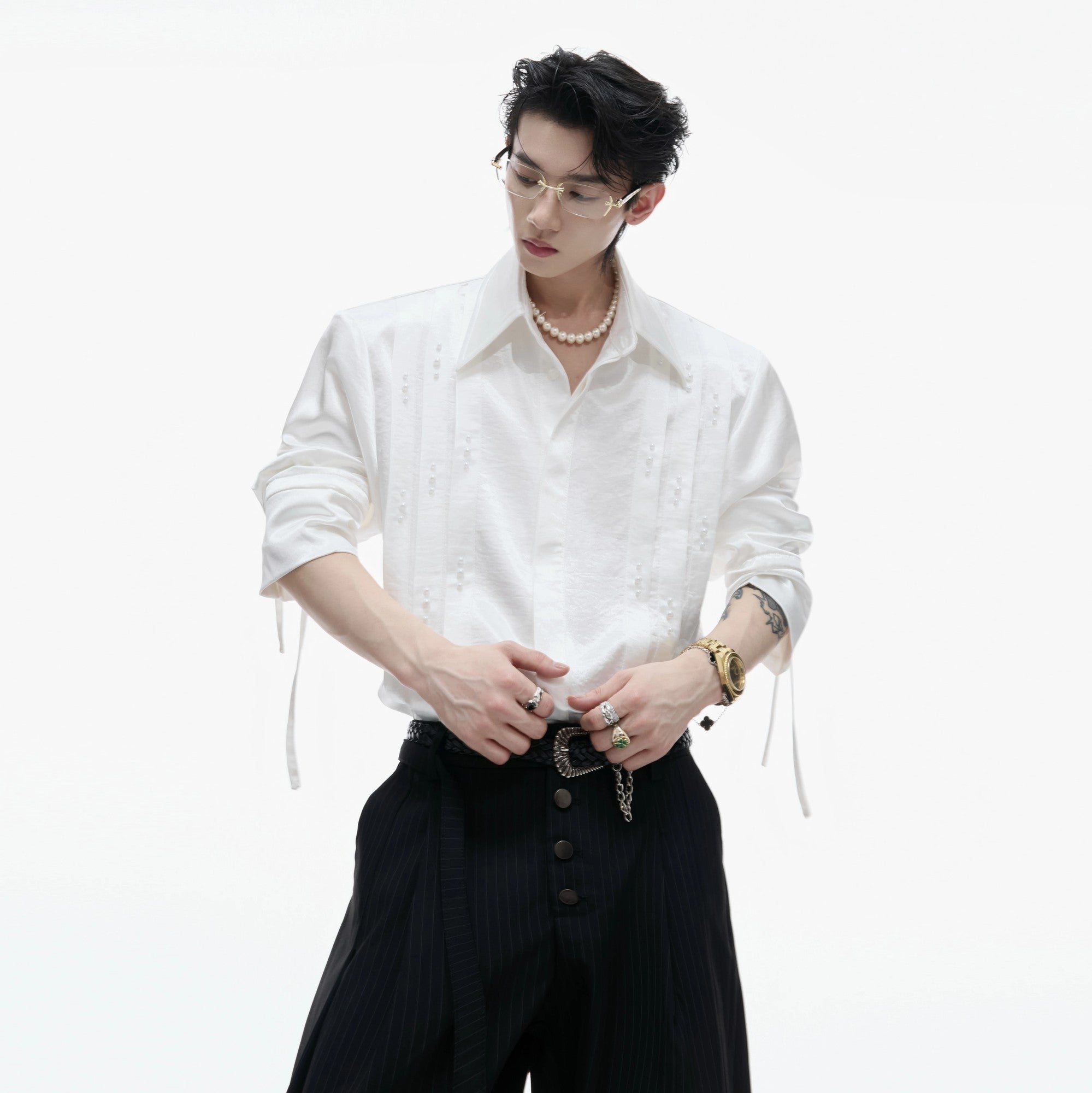 Front view of white avant-garde pleated shirt with pearl accents