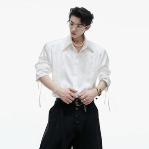 Front view of white avant-garde pleated shirt with pearl accents