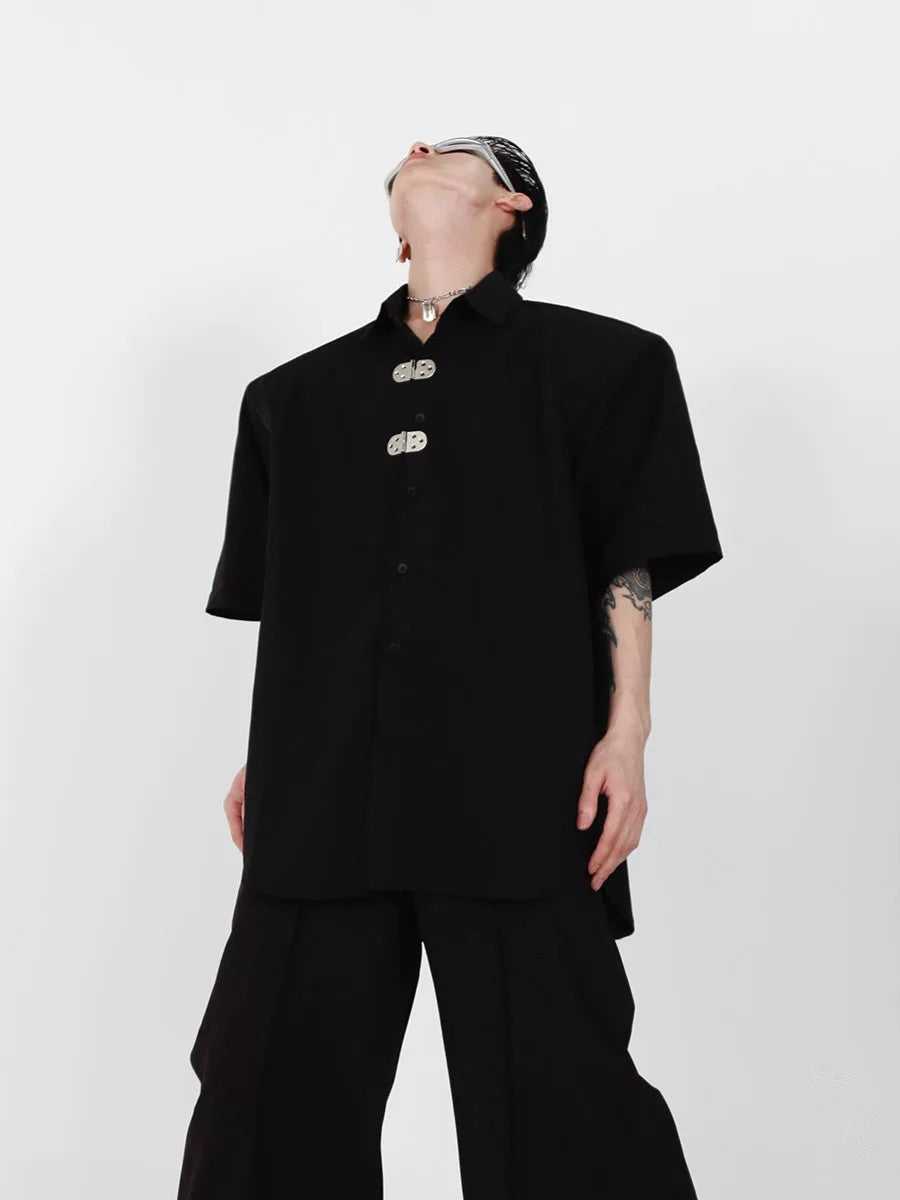 Close up of black short sleeve shirt metal buckle hardware detail