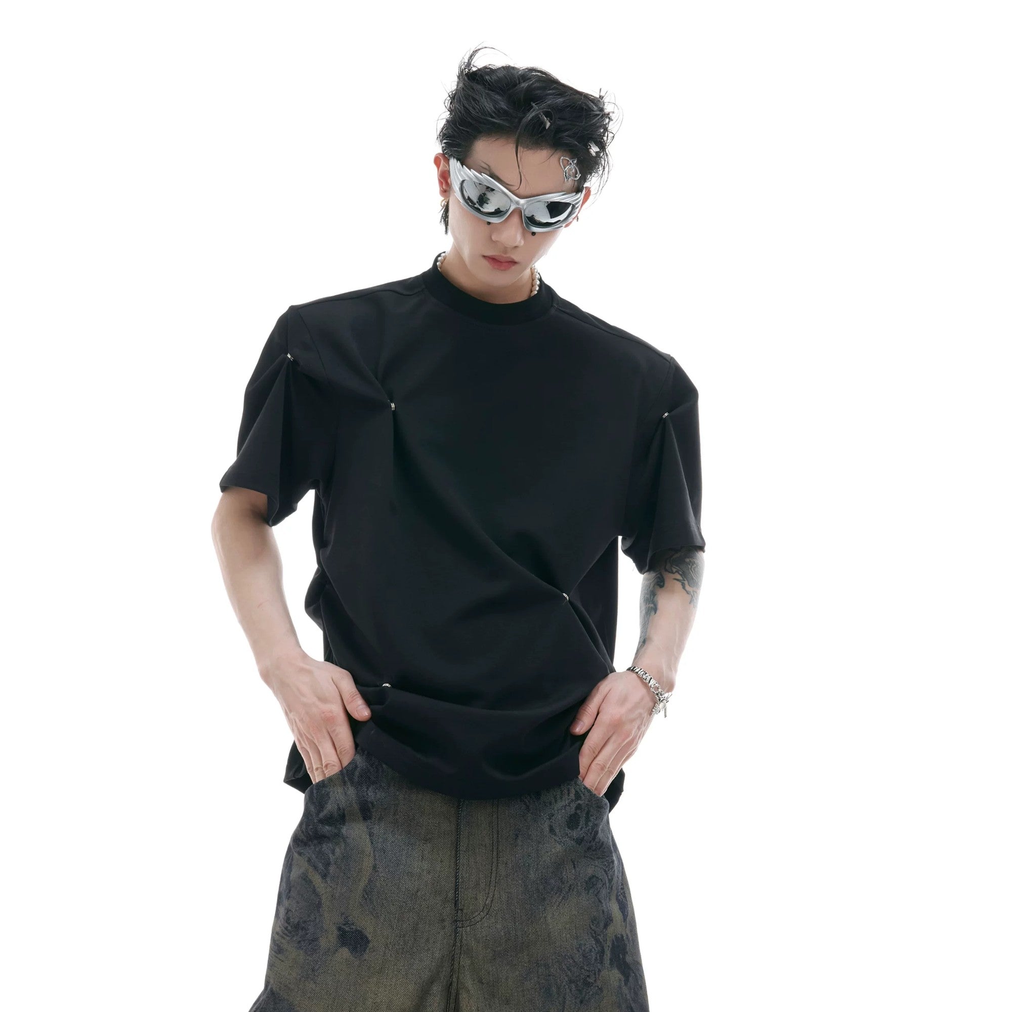 Back view of the structured shoulder design on a black pleated cotton tee