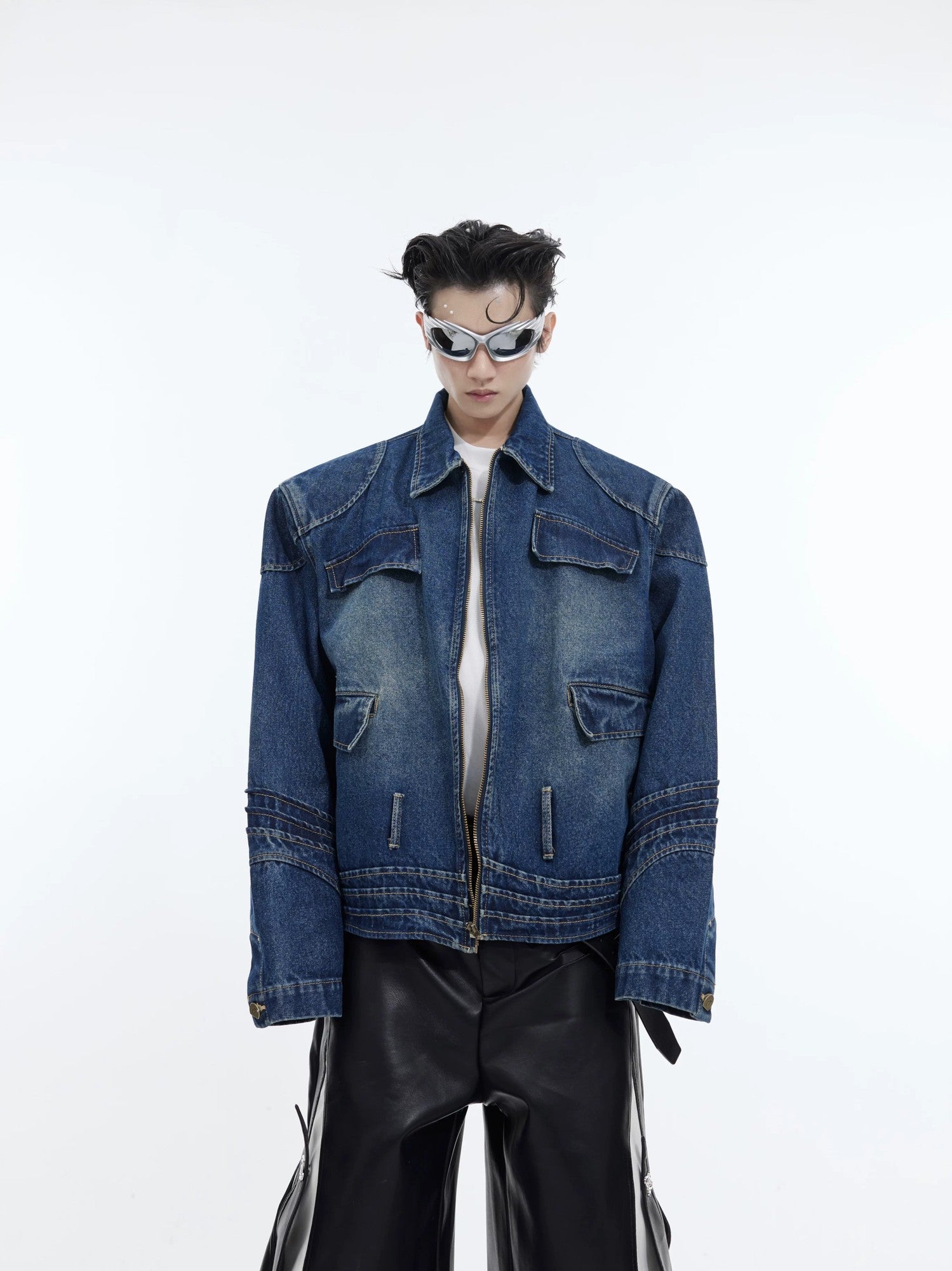 Front view of a blue deconstructed washed denim jacket with 3D paneling