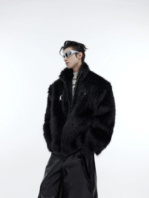 Model wearing a black oversized faux mink fur jacket with metal details.