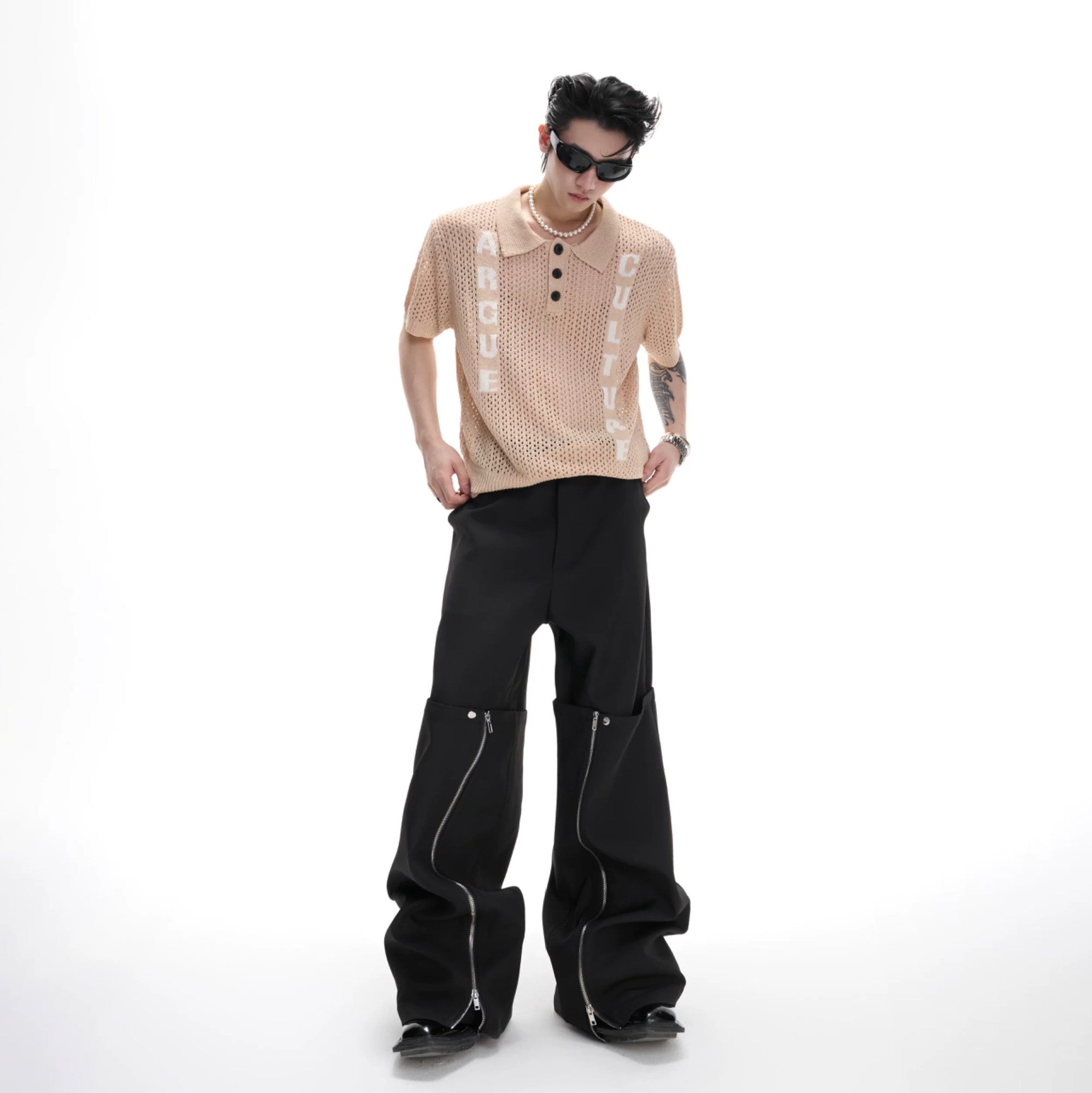 Close-up of black open-knit texture and jacquard lettering