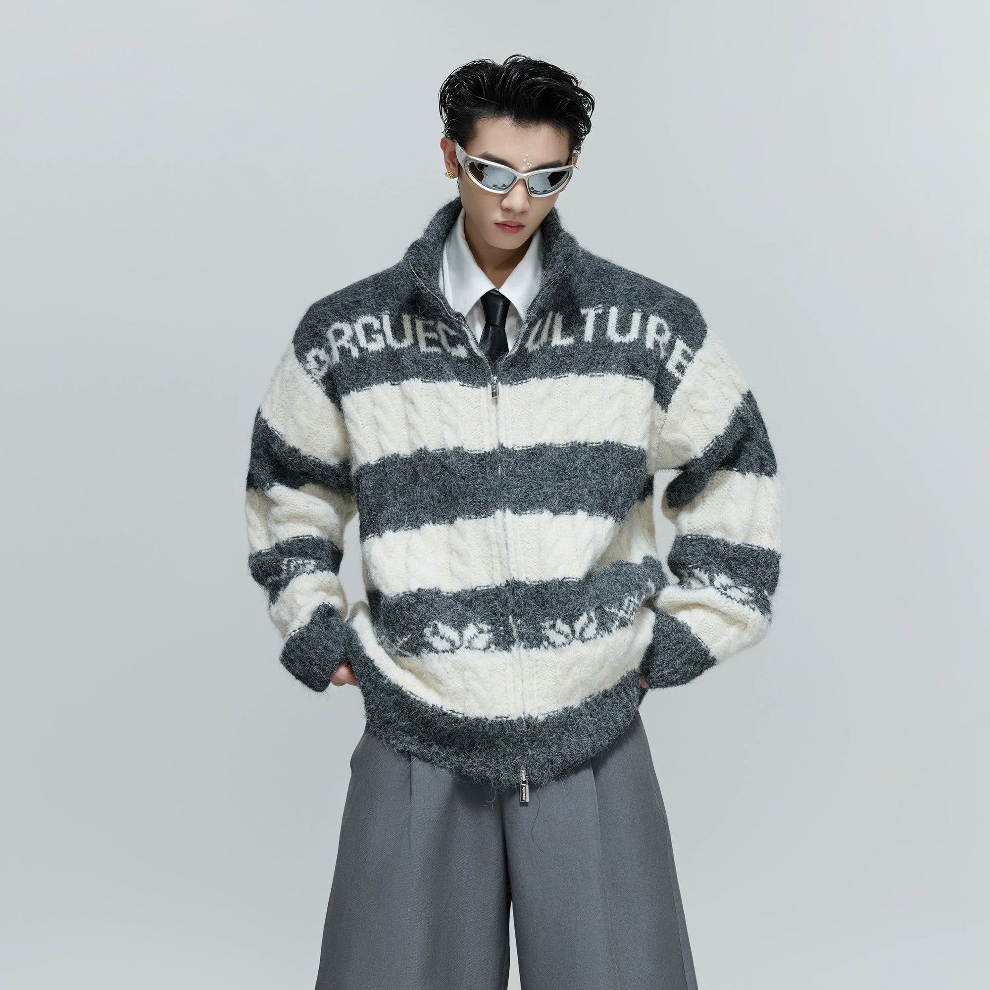 Front view of an oversized chunky knit zip cardigan in contrast black and white.