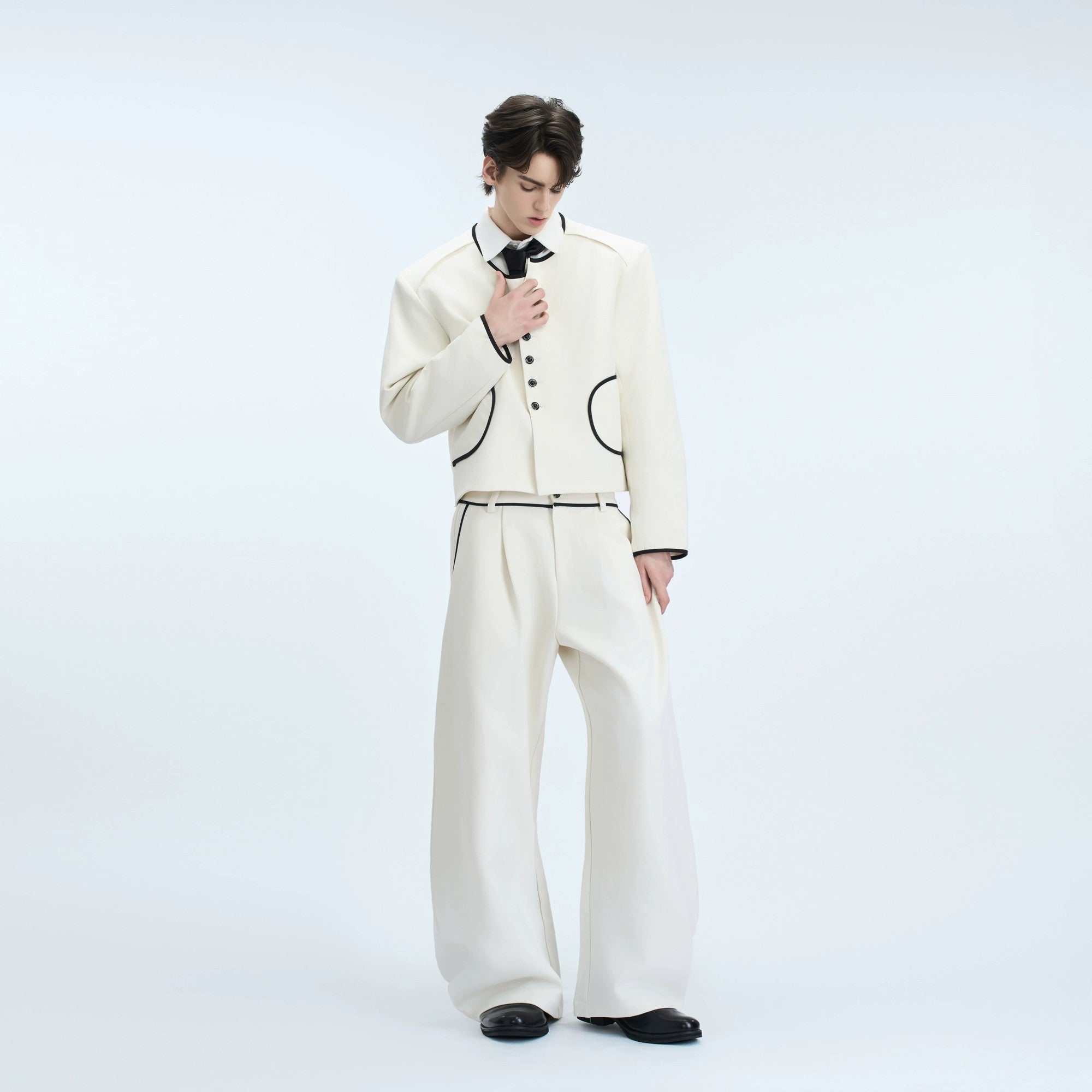 Front view of gray cropped tweed jacket with jewel buttons