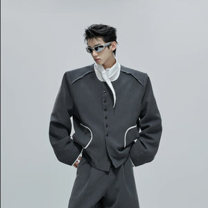 Model wearing gray tweed jacket and pants set in street setting