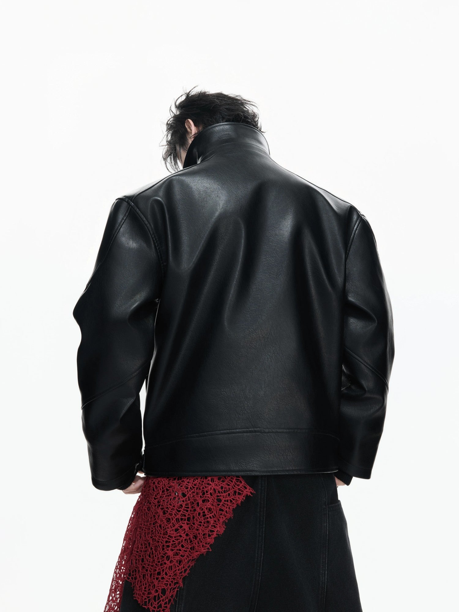 Close-up of the cracked texture and embroidery on the black leather jacket