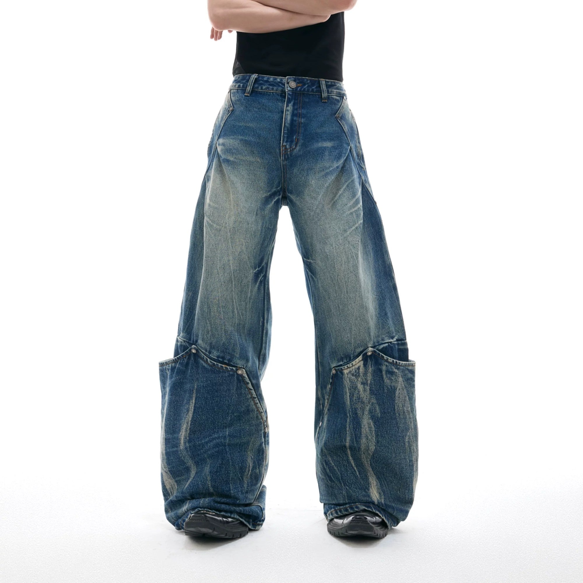 Front view of vintage blue cracked texture baggy jeans with 3D tailoring