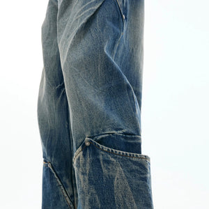 Back view of loose fit multi-pocket vintage washed blue denim