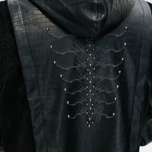 Model wearing oversized gothic padded jacket in urban setting