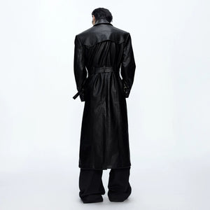 Model wearing wide-shoulder leather trench coat in urban street setting