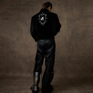 Male model wearing loose cropped shimmer jacket in urban setting