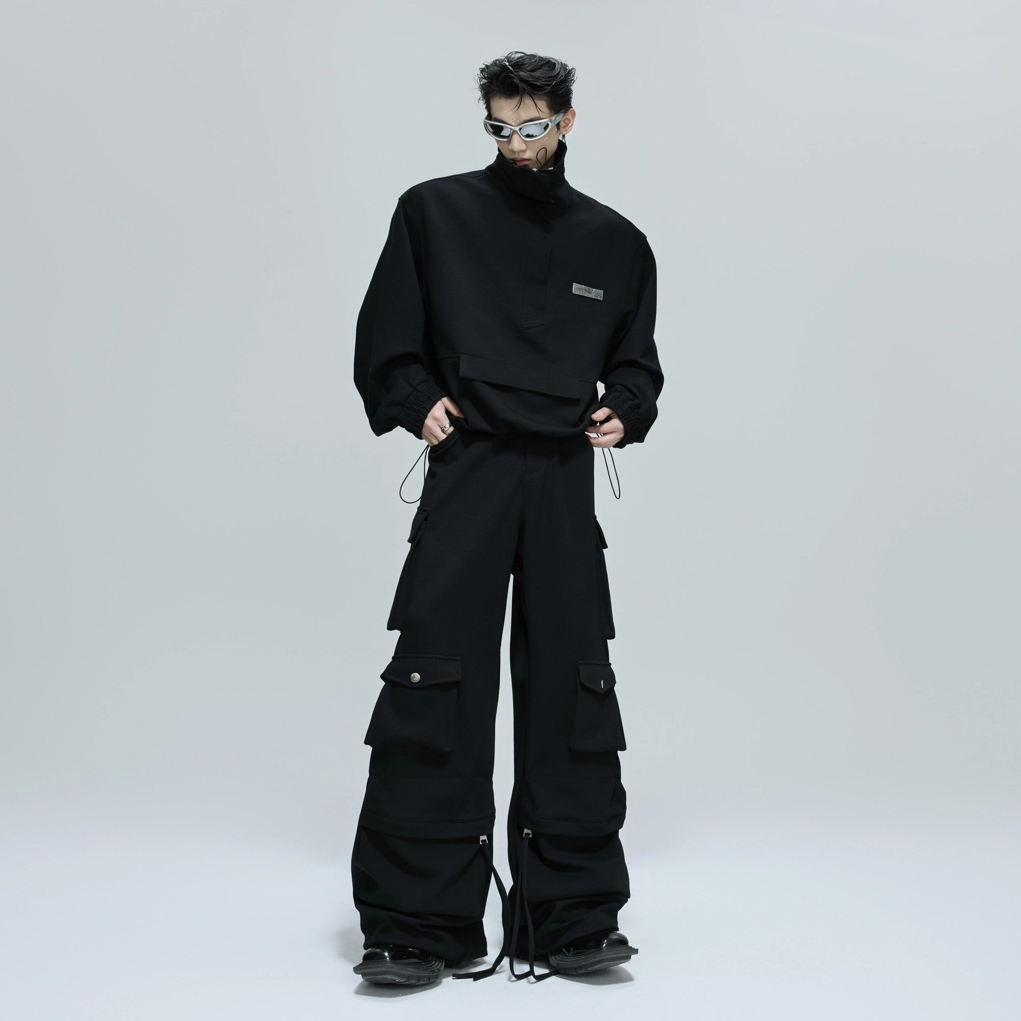 Detailed view of black heavyweight cargo pants with multi-pockets