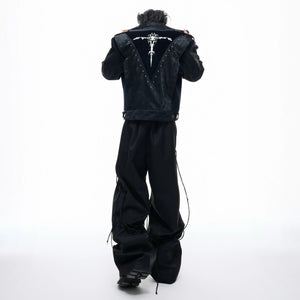 Male model wearing cropped studded biker jacket in urban setting