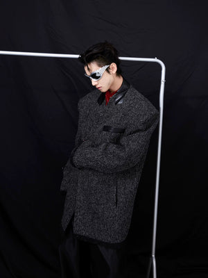 Back view of the collarless suit jacket showing the center vent design.