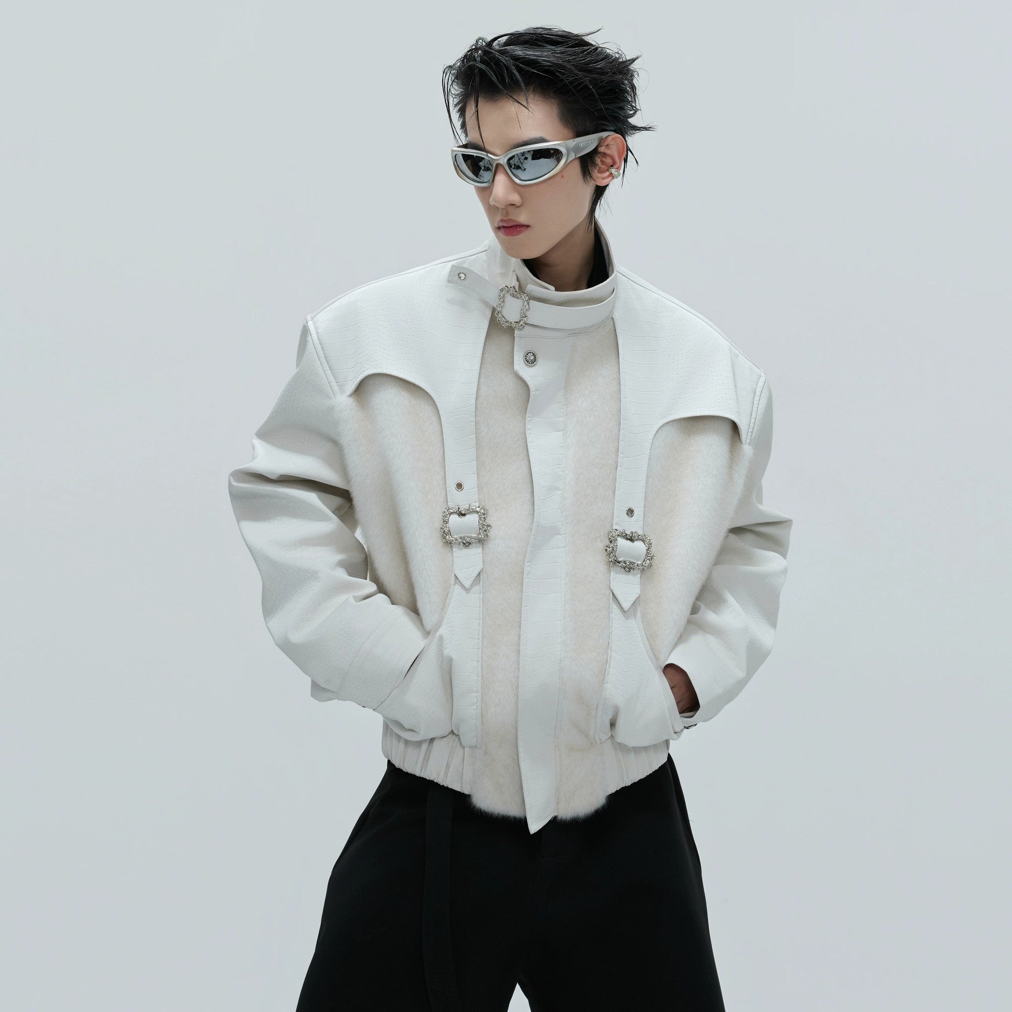 Front view of a white deconstructed crocodile texture leather jacket with buckles