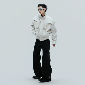 Model wearing a deconstructed crocodile jacket in an urban street setting