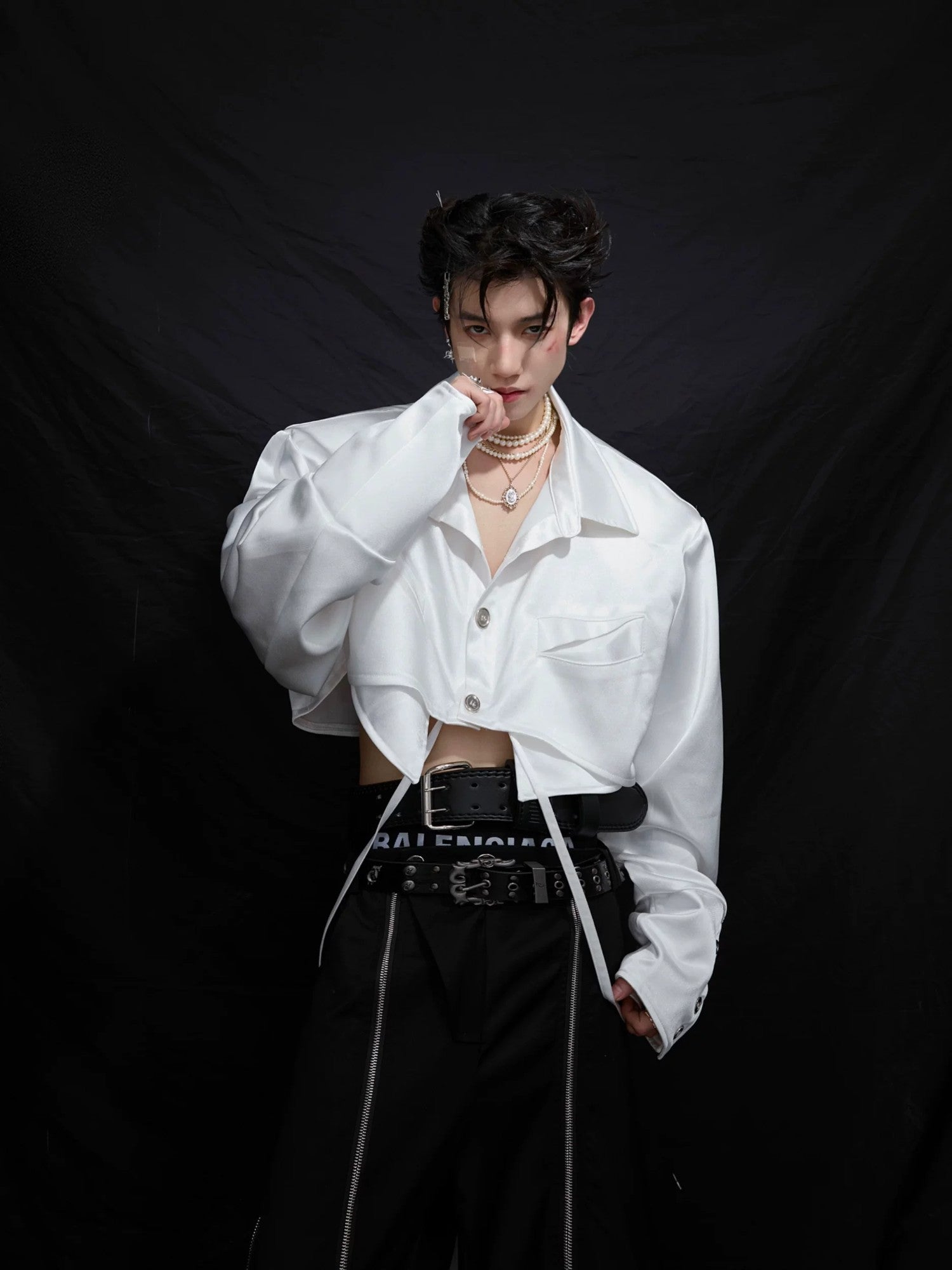 Model wearing a white deconstructed cropped shirt in a street setting