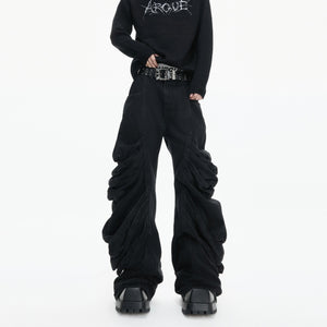 Front view of black deconstructed stacked denim jeans with pleated details