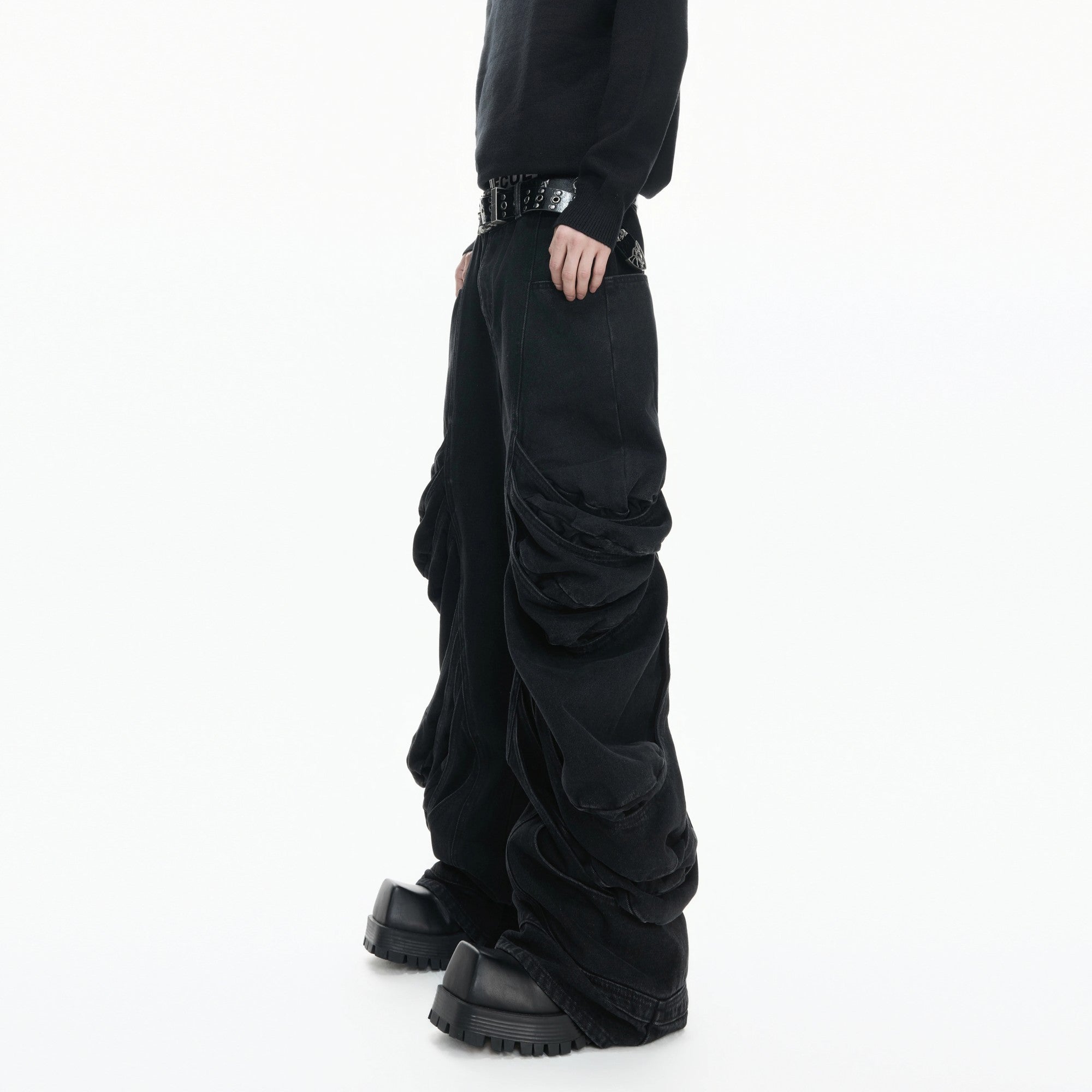 Side view of avant-garde curved leg denim showing the stacked silhouette