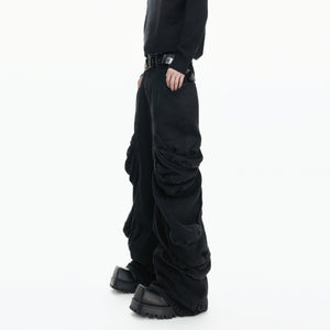 Side view of avant-garde curved leg denim showing the stacked silhouette