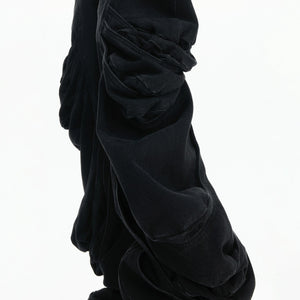 Lifestyle shot of model wearing deconstructed stacked jeans in urban setting