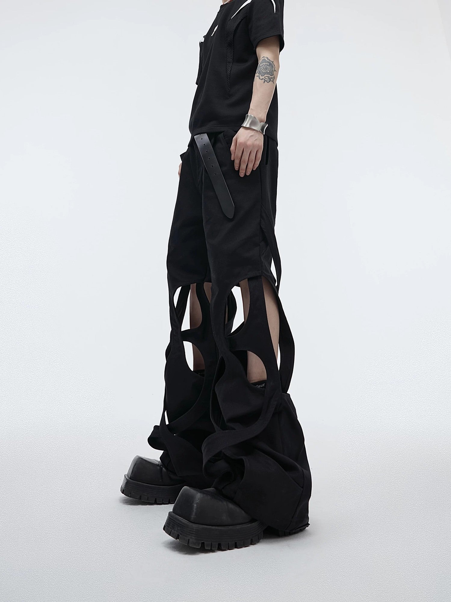 Front view of black deconstructed cut-out streetwear cargo pants