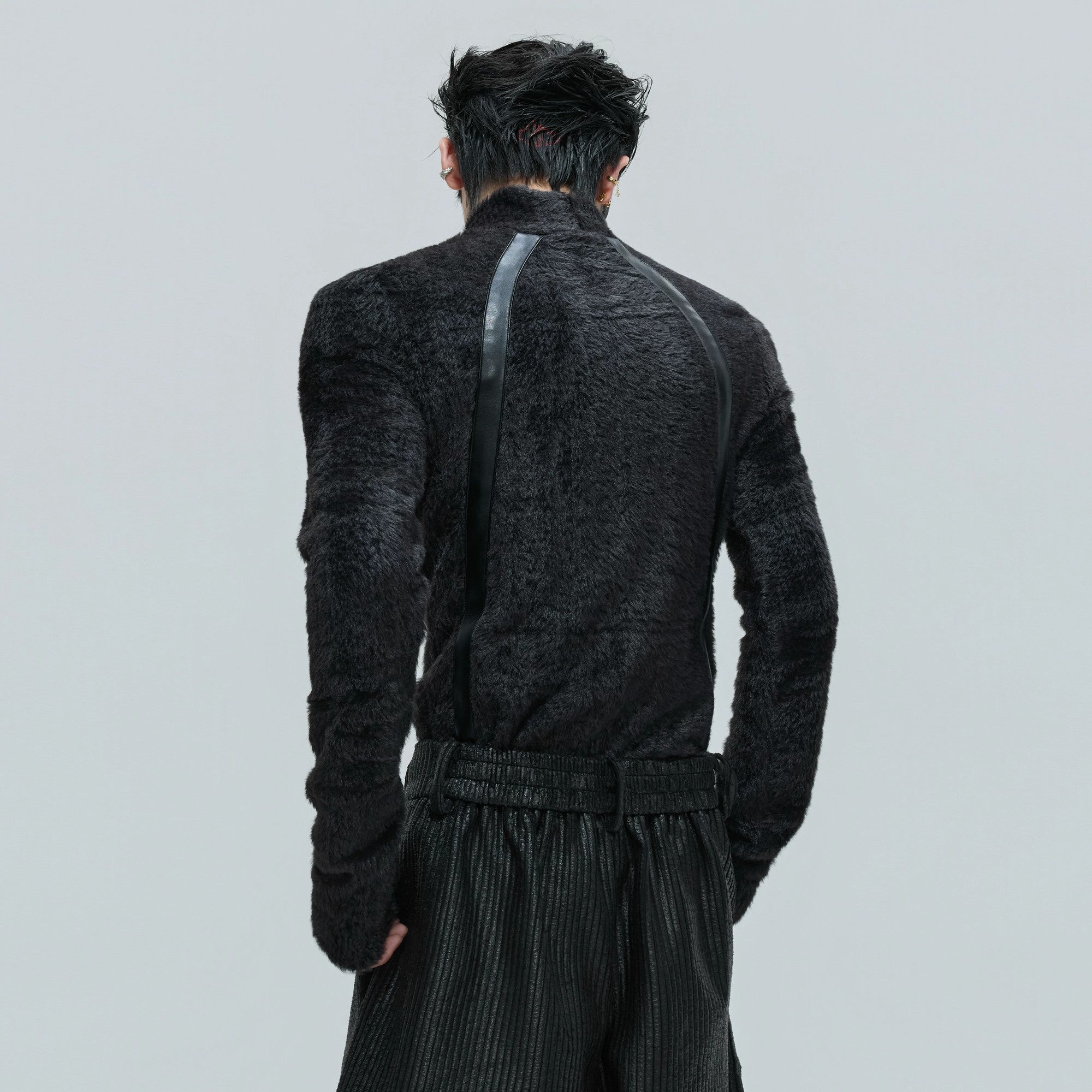 Close up of faux mink plush fabric and matte leather strip detailing