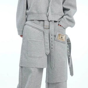 Model wearing oversized faux two-piece streetwear set in urban setting