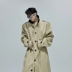 Model wearing a khaki longline deconstructed overcoat in an urban setting