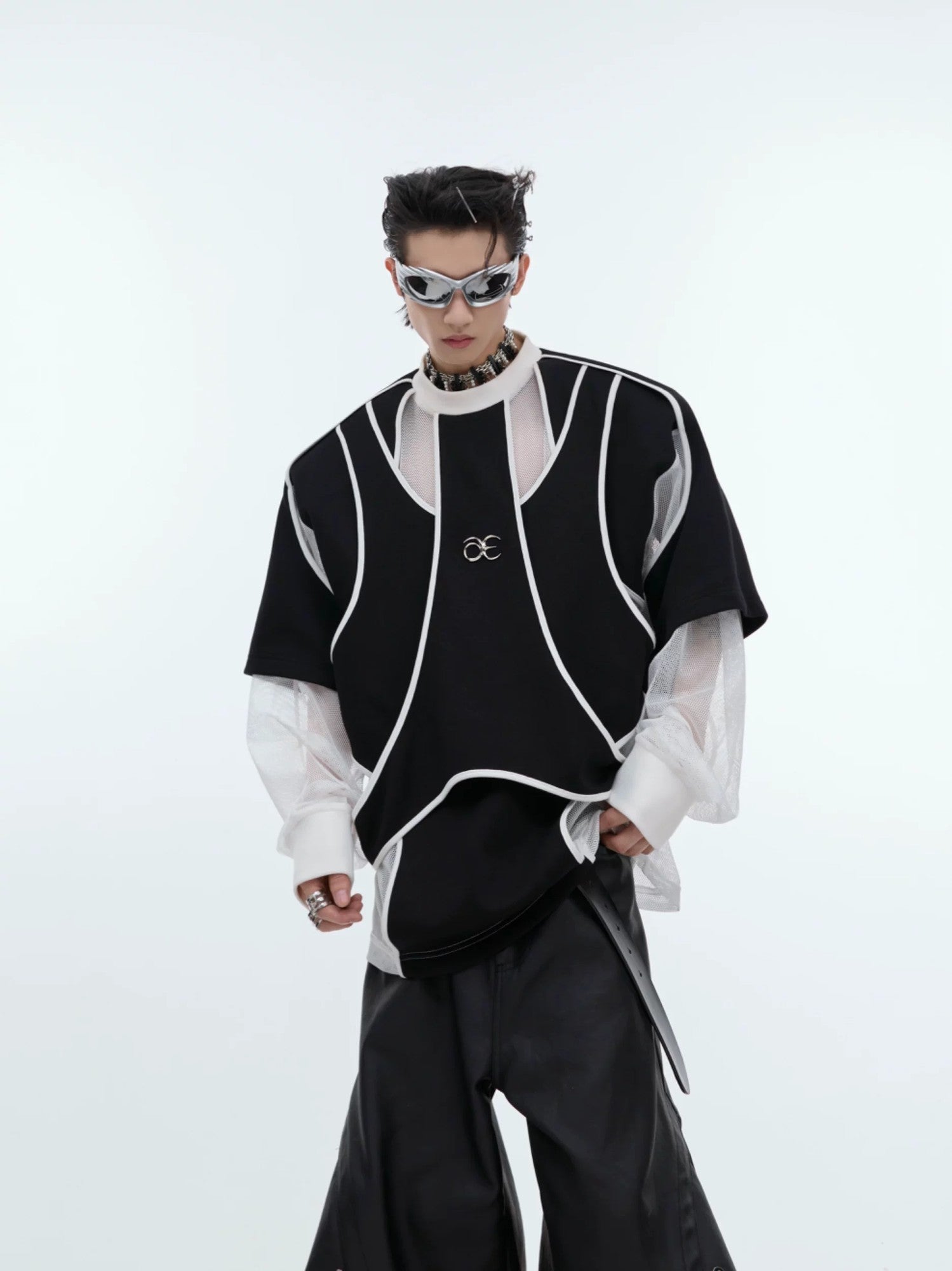 Front view of black deconstructed faux two-piece sweatshirt with shoulder pads