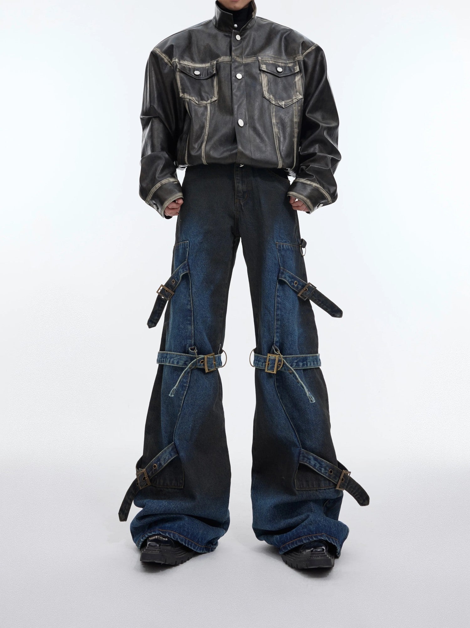 Front view of blue deconstructed flare jeans with metal buckles and lace-up design.