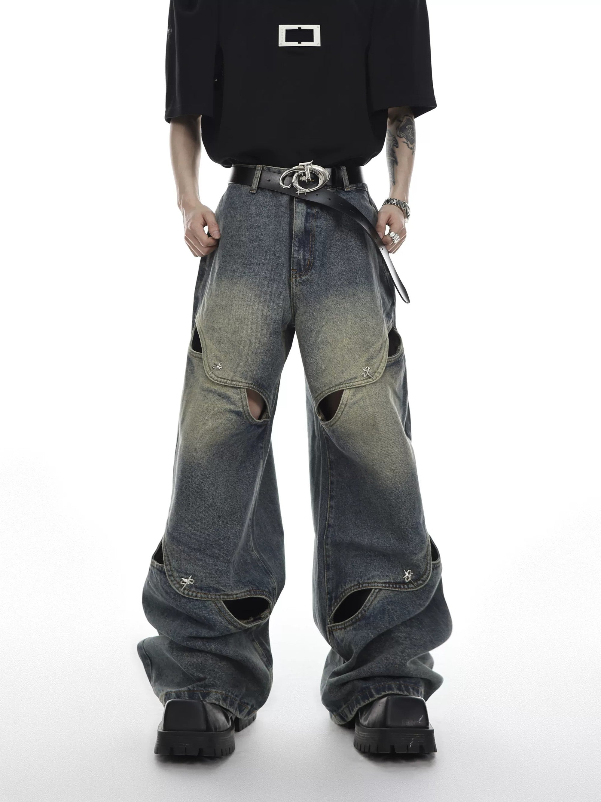 Front view of men's deconstructed hollow-out wide leg jeans in vintage wash