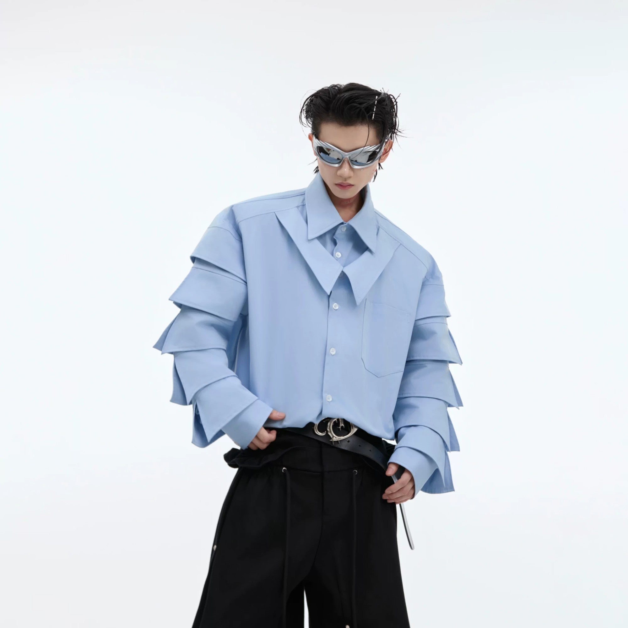 Side view showing 3D pleated sleeve details on a blue streetwear shirt