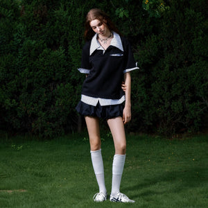 Close-up of the polo collar and metal button design