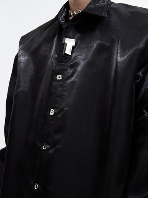 Close up of metal button details and padded shoulder construction