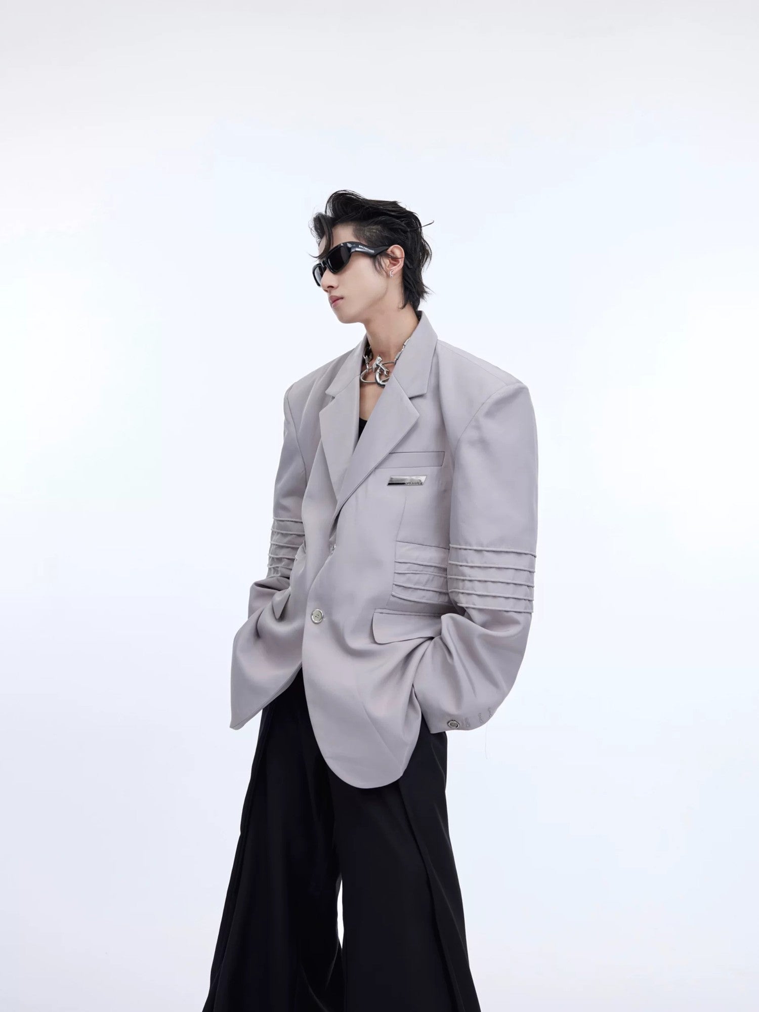 Model wearing a gray deconstructed liquid shine oversized blazer jacket