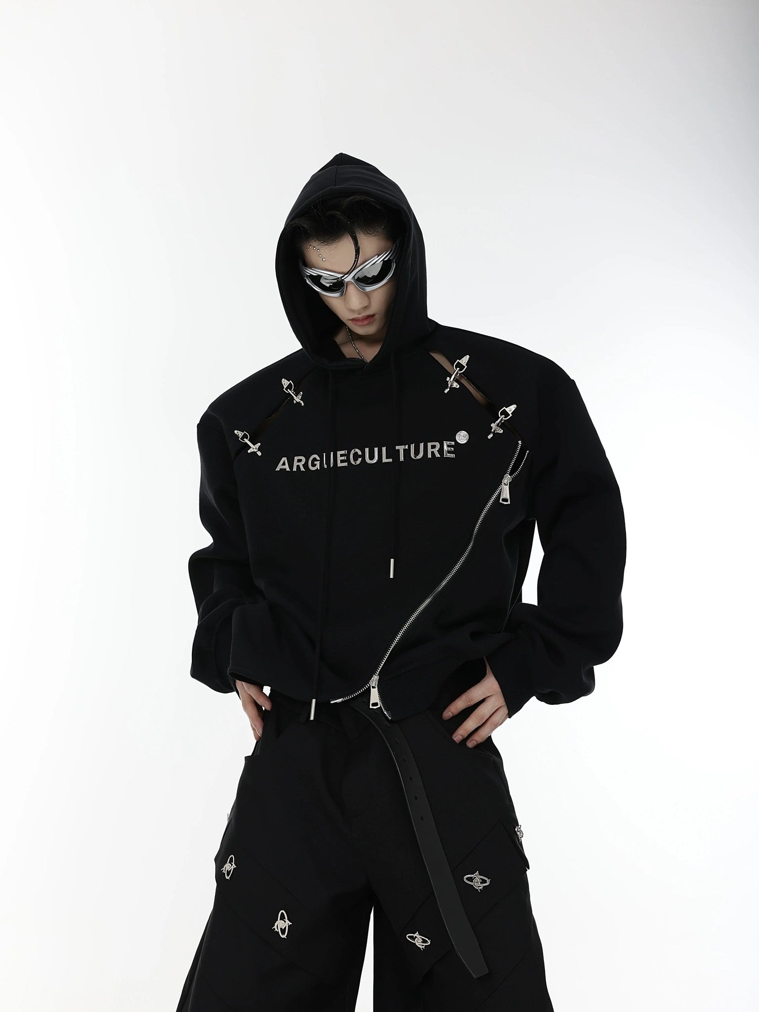 Side view of white futuristic hoodie showing hollow-out splicing and metal zippers.