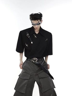 Close-up of asymmetric metal buckle neckline and shoulder pad detail