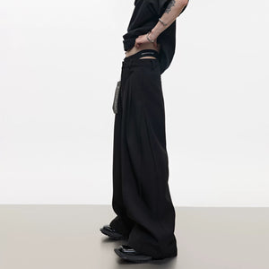 Front view of deconstructed wide-leg pants with metal zipper detail