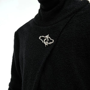 Close up of high-end metal logo branding on the mock neck collar