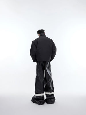 Male model wearing deconstructed zip puffer jacket with baggy pants