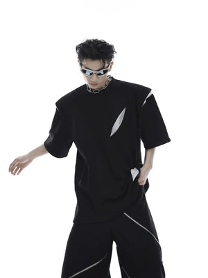 Front view of black deconstructed patchwork T-shirt with padded shoulders